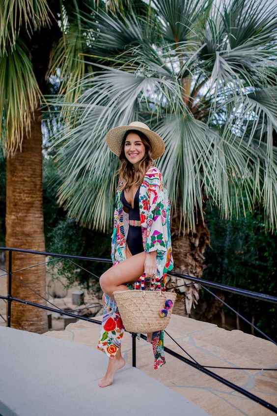 Picture Of a colorful floral beach kimono paired with a black one .