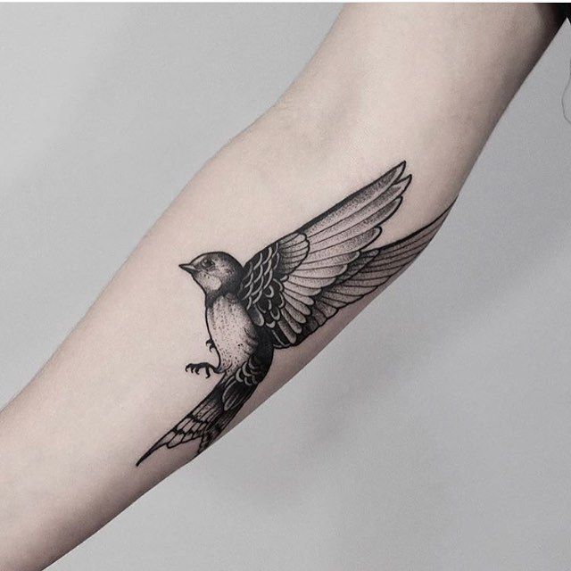 Blackwork bird tattoo by Jonas Ribeiro inked on the right forearm .