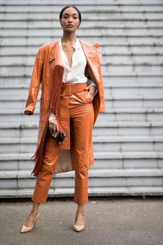 Picture Of a rust colroed lacquered leather trench and matching .