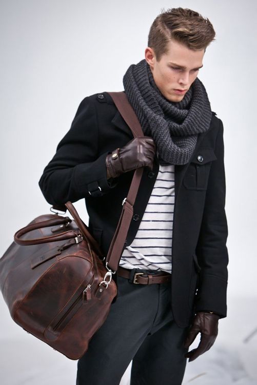 Grey infinity scarf, b/w shirt under a black coat accessorized .