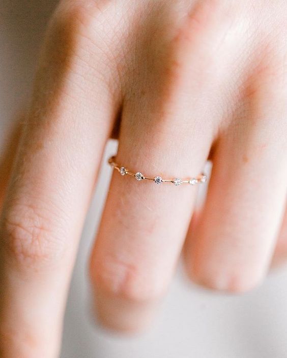 Picture Of a minimalist gold ring dotted with diamonds is a very .