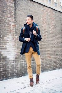 With striped shirt, navy blue coat, brown leather backpack and mid .