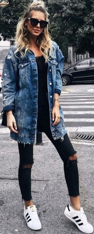 this oversized distressed denim jacket paired with frayed black .