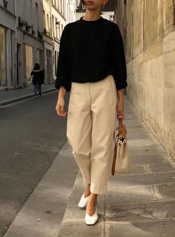Picture Of a black jumper, neutral oversized cropped pants, white .