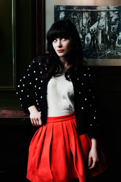 Zooey's red pleated skirt and polka dot cardigan in Forbes article .