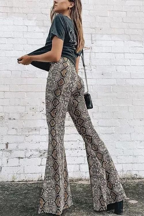 Take a walk on the wild side with these snake print flared pants .