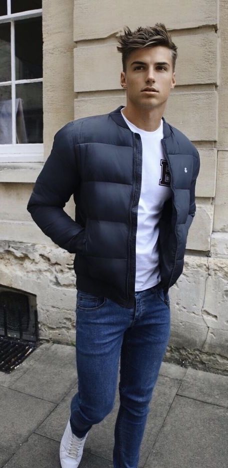 Fall fashion with a navy puffer jacket white printed t shirt denim .