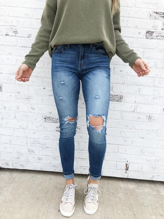 Keystone. Ripped denim jeans. Hole ripped details. Blue jeans .
