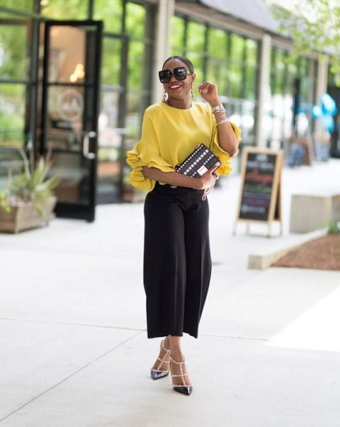 Picture Of a casual yet outfit with black culottes, a sunny yellow .