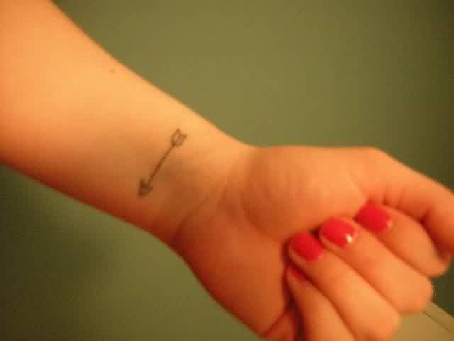 Tiny Arrow Tattoo On Women's Wri