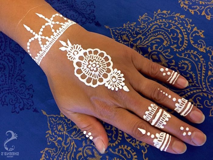 simple-white-small-henna-tattoo-featuring-a-floral-motif-finger .