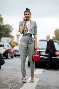 a grey plaid pantsuit with a cropped jacket, blakc heels and a red .
