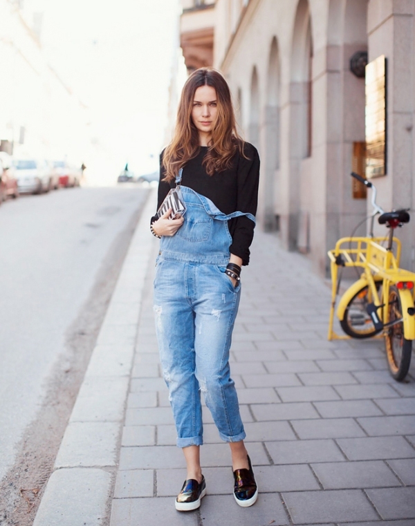 Picture Of a black top, a blue denim dungaree and black slipons .