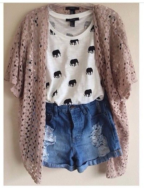 Loose top tucked into high waist shorts with a slouchy cardigan .