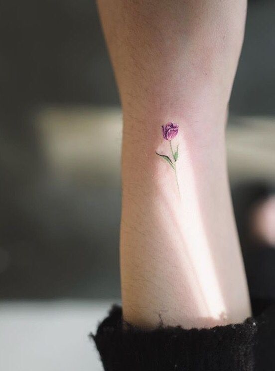 Tiny colourful tulip tattoo on the wrist. #flower #tulip #tattoo .