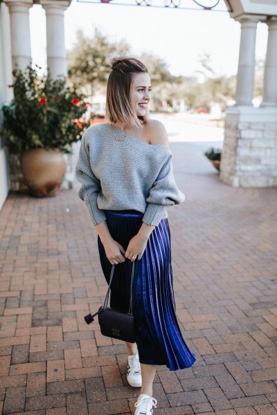 gray one-shoulder sweater with dark blue pleated midi skirt
