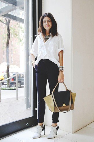 white oversized shirt with tall dress pants and light gray heeled boots
