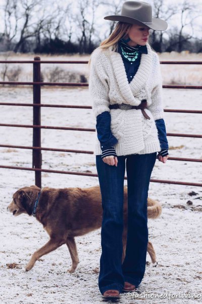 White belted wrap sweater, blue flared jeans and black square toe boots