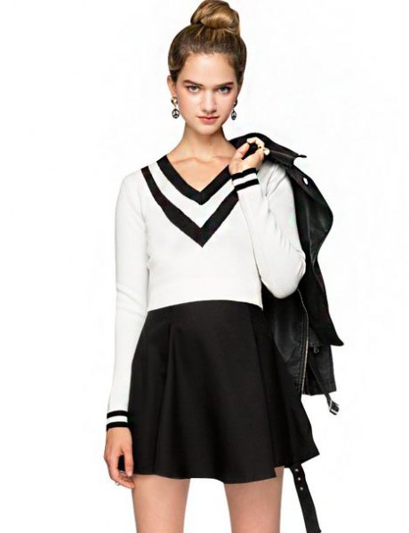 White and black V-neck sweater with high-waisted mini skirt