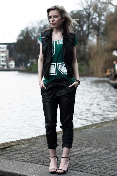 black vest with gray printed t-shirt and leather trousers