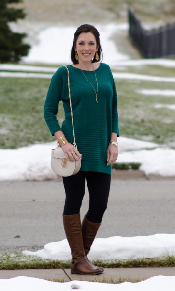 long-sleeved striped sweater with black leggings and brown leather boots