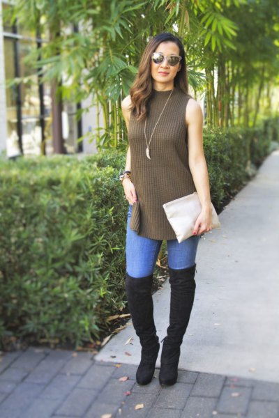 ripped long sweater with a green mock neck and black overknee boots