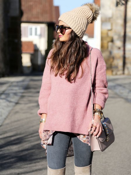 Blush pink cashmere sweater with a knit beanie and over-the-knee boots