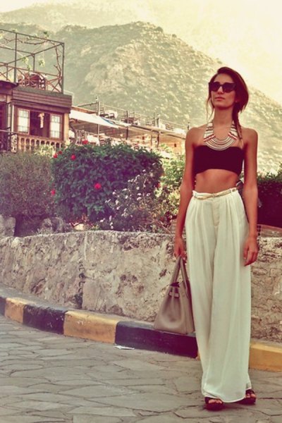 black cropped tube top with white wide-leg pants
