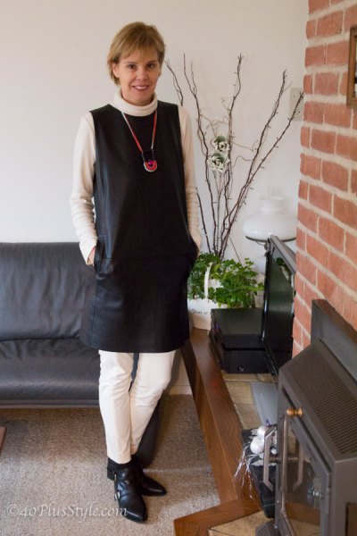 black sleeveless leather mini dress with white slim fit pants