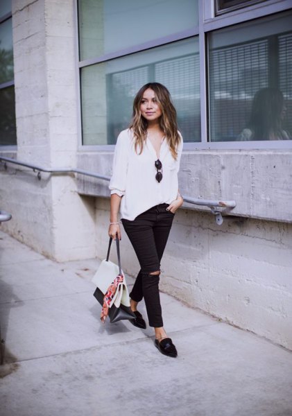white relaxed fit blouse and black slip fit jeans and slippers