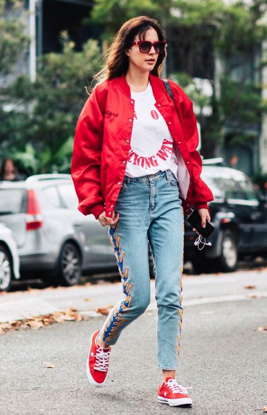 red bomber jacket with white graphic tee and embroidered mom jeans