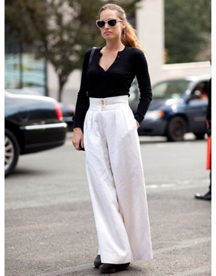 black V-neck sweater and white palazzo pants