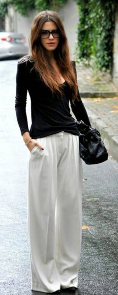 black bodycon sweater with scoop neck and white pants