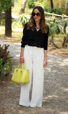 black button down shirt and white trousers and lemon yellow leather handbag