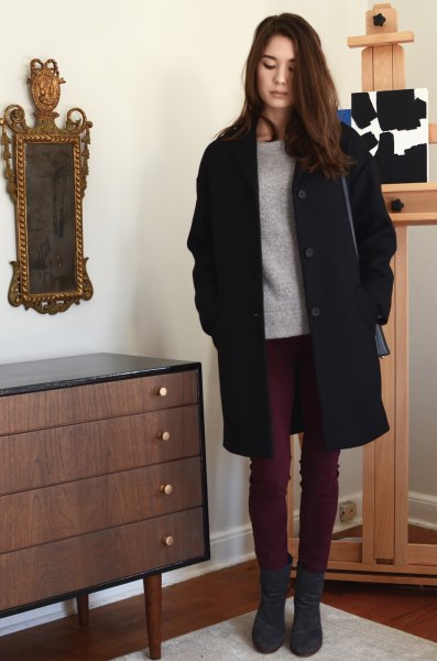 black long coat with gray sweater and dark skinny jeans