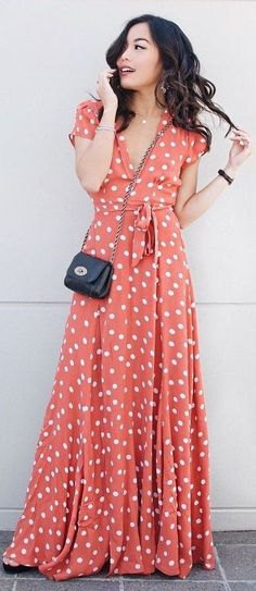 floor-length flared dress with orange and white polka dots
