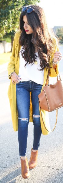 yellow longline cardigan sweater with white blouse and ripped knee jeans