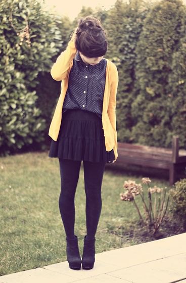 Cardigan worn with a black polka dot shirt with a mini pleated skirt
