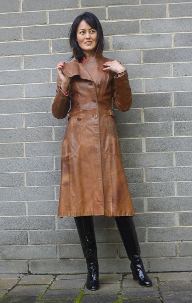 brown leather trench coat with pink mock-neck sweater