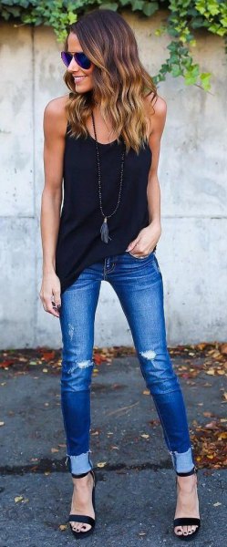 black long tank top with blue skinny jeans with cuffs