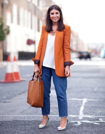 Long orange blazer with a white vest top and wide-leg mom jeans
