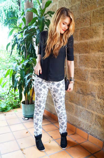 Black half sleeve sweater and white and pink printed relaxed fit pants