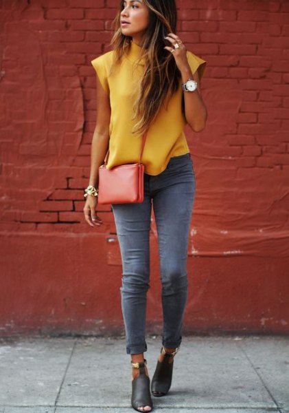 Sleeveless blouse with a mustard mock neck and gray skinny jeans with cuffs