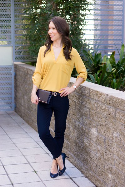 Lighter mustard-colored blouse with a V-neckline and chinos