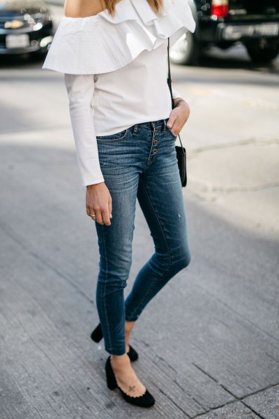 white off-the-shoulder blouse with ruffles and button-down jeans