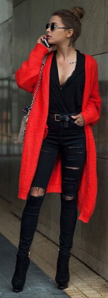 red midi cardigan with black deep V-neck blouse and ripped jeans