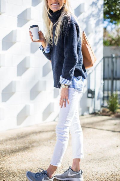 Navy sweater worn with a blue and white striped button down shirt