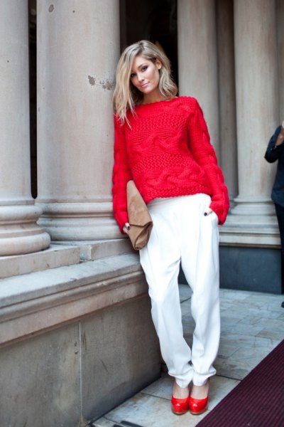 Red cable knit sweater with white relaxed fit pants