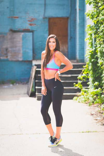 Pink sports bra top with cropped black Nike jogging tights