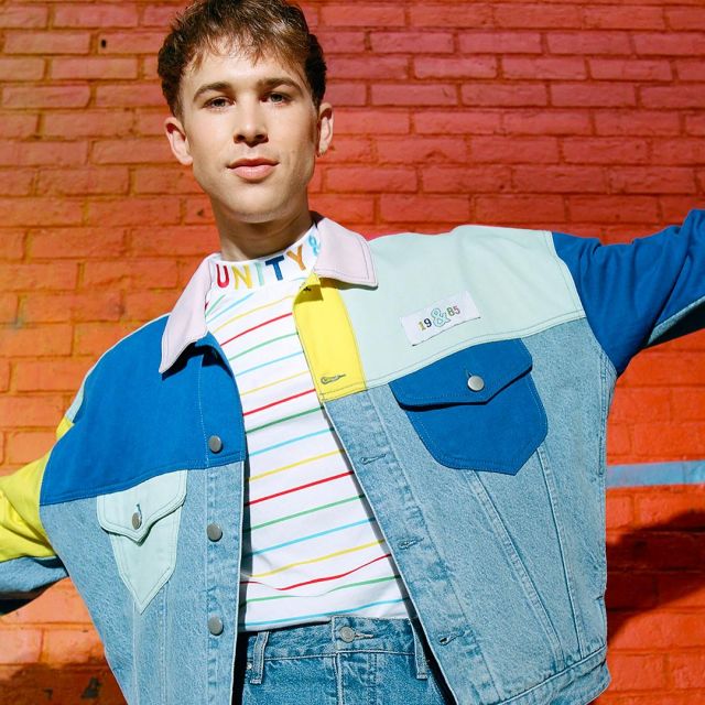 The denim jacket colors block Tommy Dorfman on one of his posts.